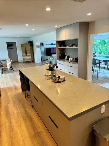a kitchen with a table chairs and a refrigerator