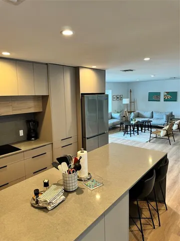 a kitchen with stainless steel appliances a stove a microwave and white cabinets