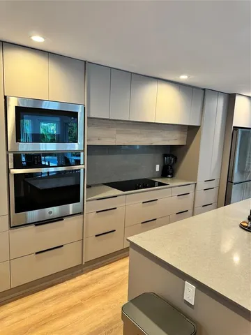 a kitchen with stainless steel appliances a sink and a stove