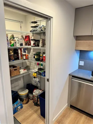 a living room with furniture a flat screen tv and a floor to ceiling window