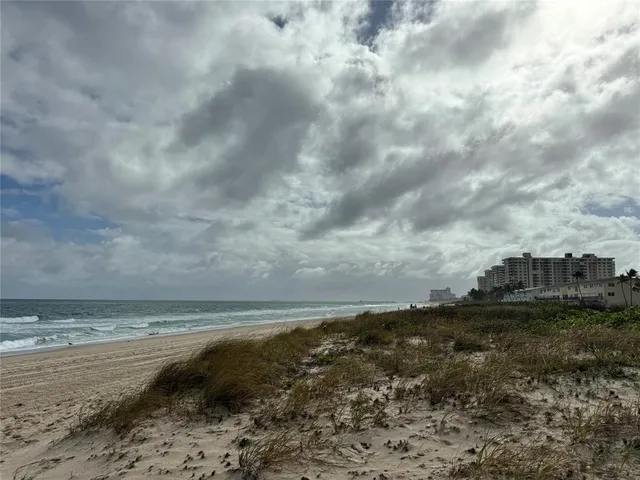 a view of fountain in middle of the green field