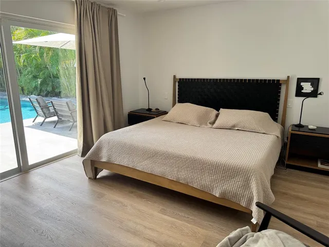 a bedroom with two beds and a window