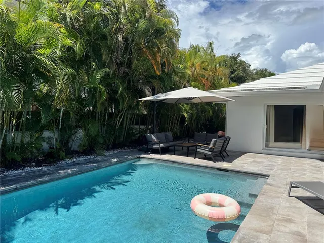 a patio with patio a table and chairs under an umbrella