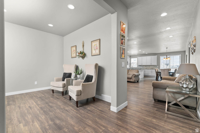 5686 Duke Lane Tooele, UT 84074 - Photo 23 of 38 Sitting room with dark wood-style flooring and suspended lighting