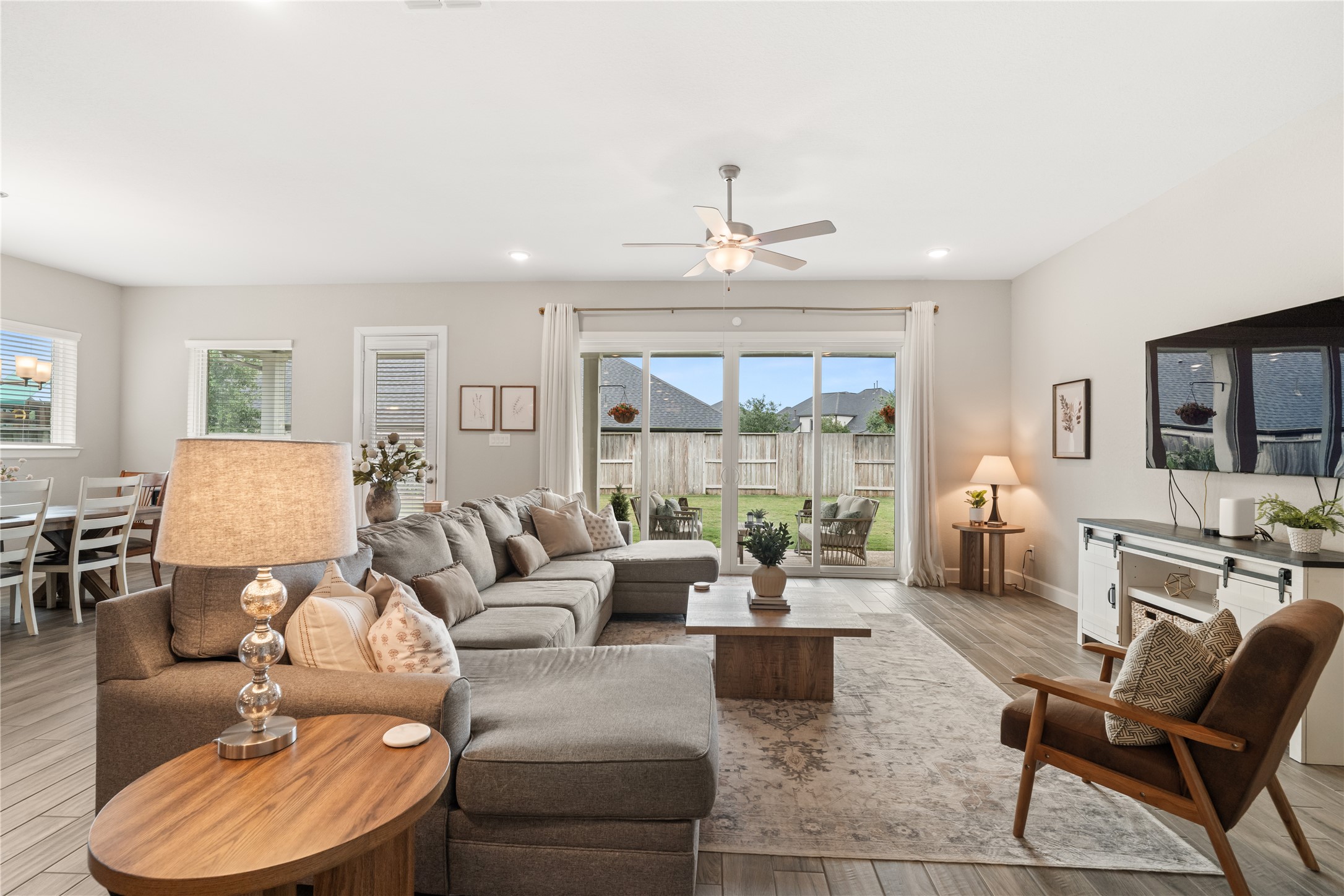 3118 Swift Way Katy, TX 77493 - Photo 10 of 34 Living Room – Bright and spacious open-concept living area featuring large sliding glass doors, abundant natural light, and seamless flow to the outdoor patio.