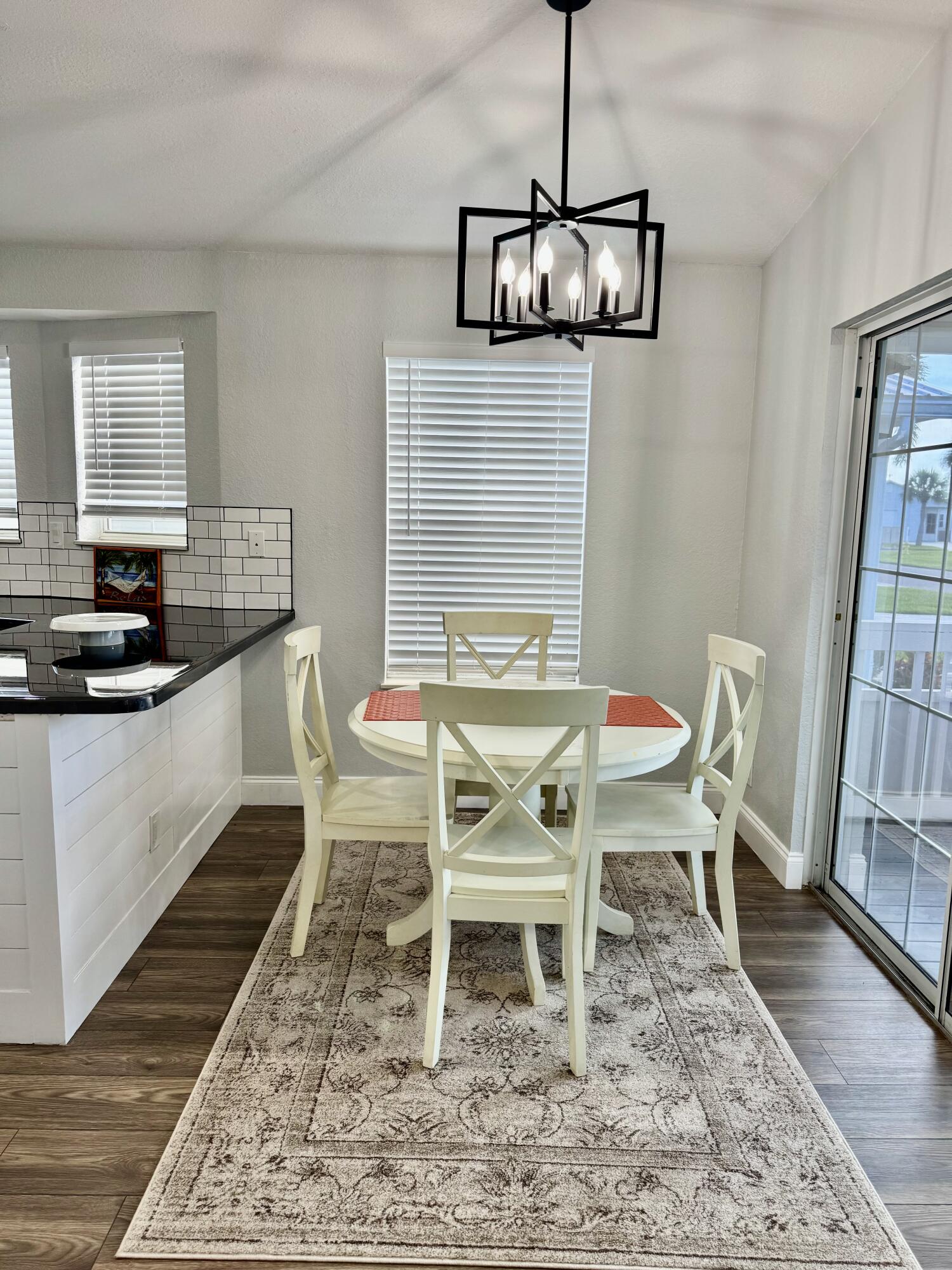 4350 Southwest 13th Avenue Okeechobee, FL 34974 - Photo 14 of 43 a dining room with furniture a rug and wooden floor