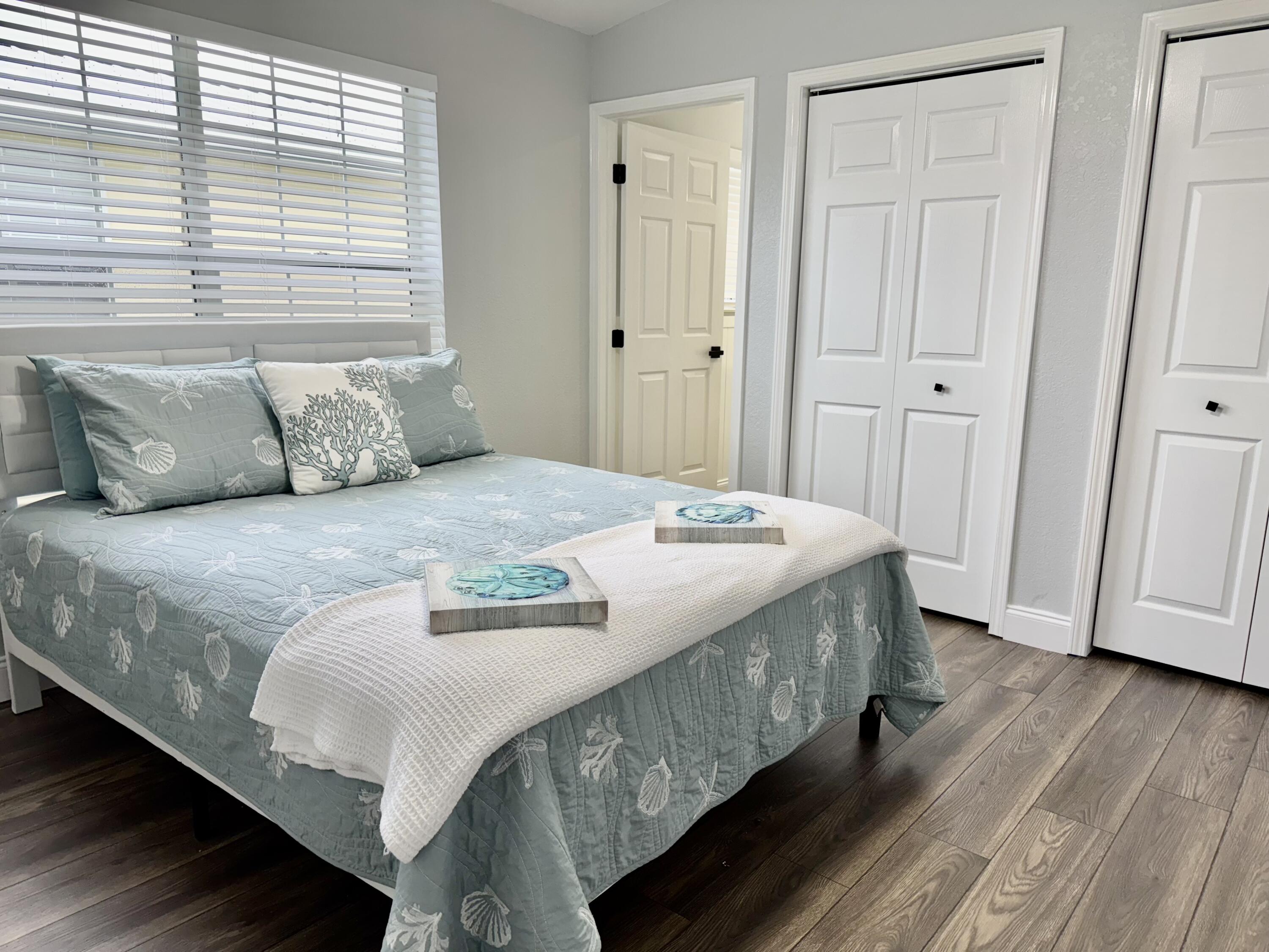 4350 Southwest 13th Avenue Okeechobee, FL 34974 - Photo 17 of 43 a bedroom with a bed and a wooden floor