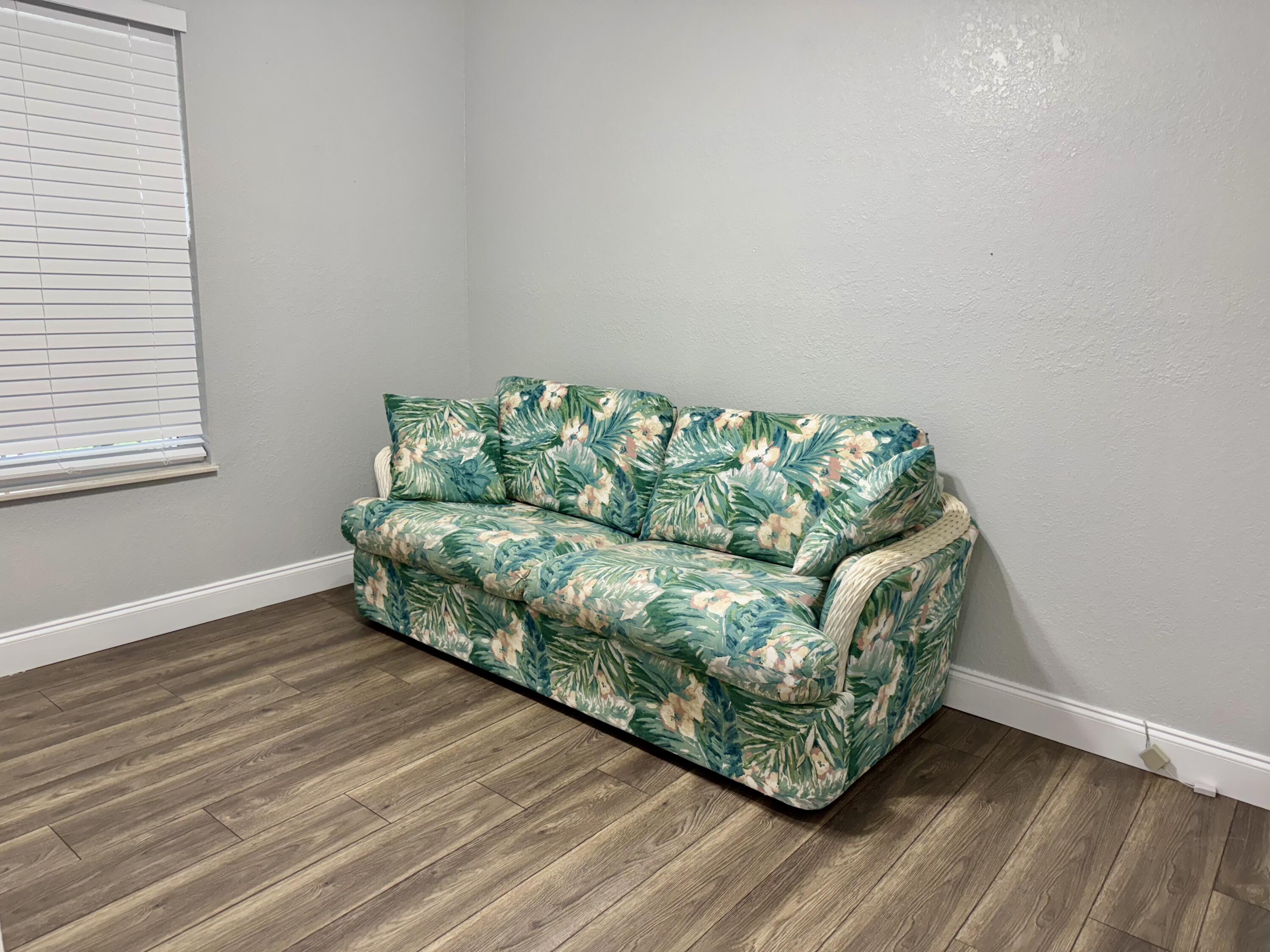 4350 Southwest 13th Avenue Okeechobee, FL 34974 - Photo 21 of 43 a living room with couch and a wooden floor