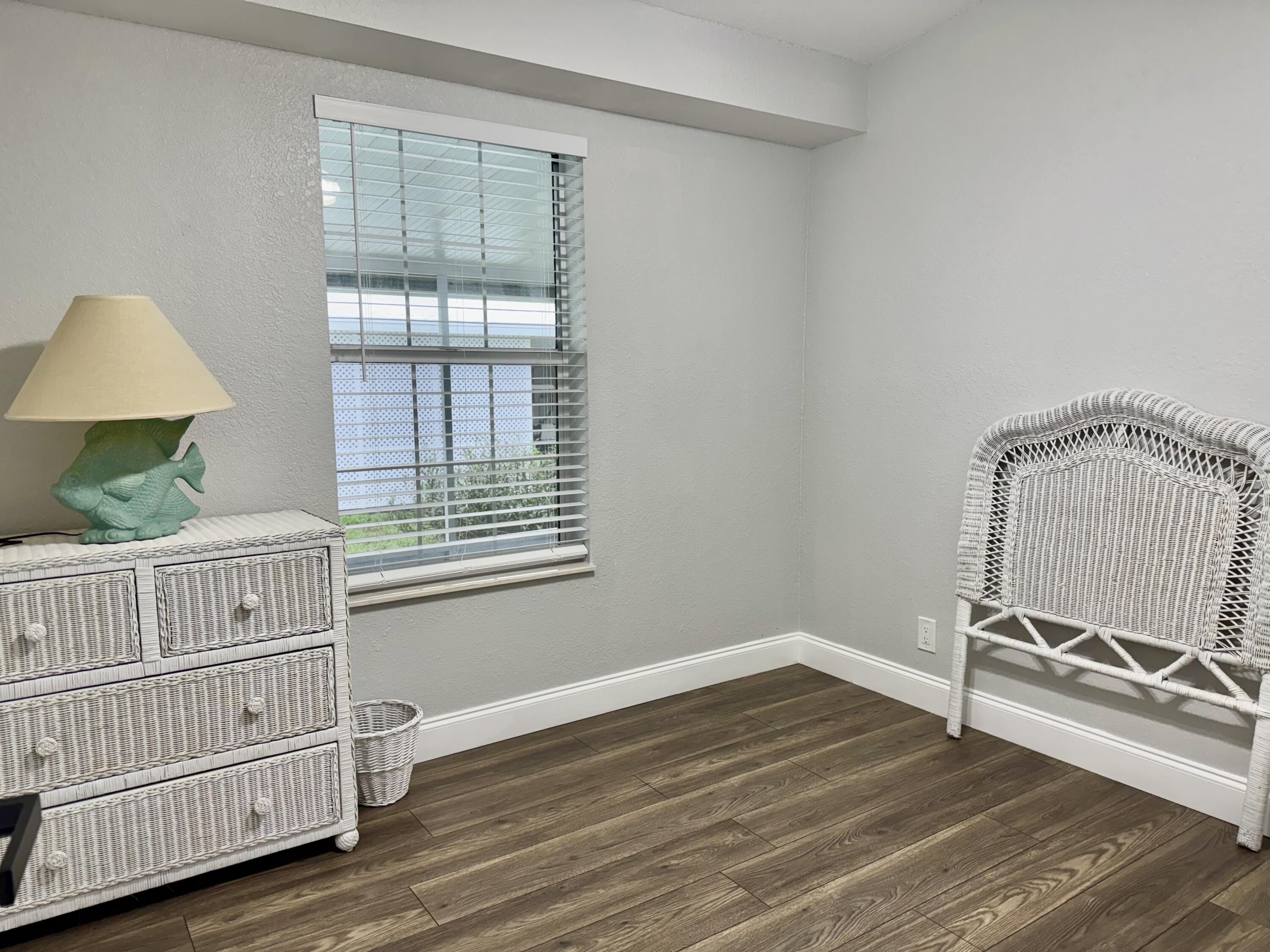 4350 Southwest 13th Avenue Okeechobee, FL 34974 - Photo 7 of 43 a view of a room with wooden floor fan and windows