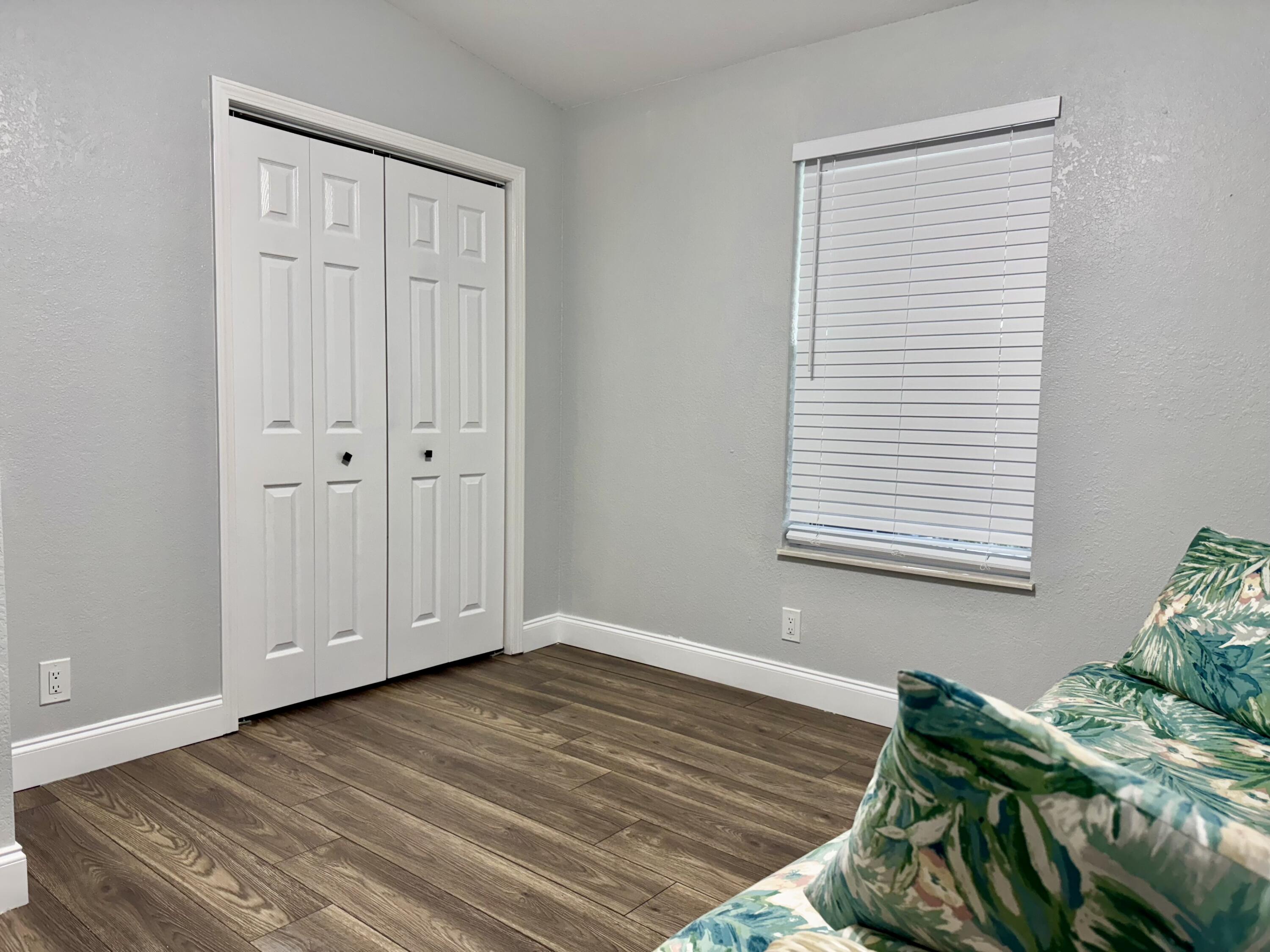 4350 Southwest 13th Avenue Okeechobee, FL 34974 - Photo 9 of 43 a view of a livingroom with wooden floor and closet