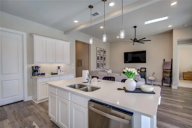 a kitchen with sink a counter and cabinets