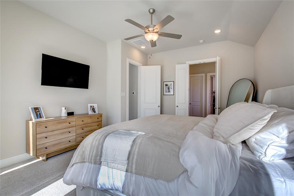 1872 Big Spring Drive Forney, TX 75126 - Photo 17 of 40 a bedroom with a large bed and a flat screen tv