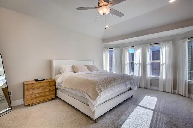 a bedroom with a large bed and a flat screen tv