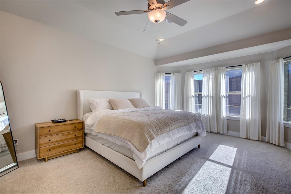 1872 Big Spring Drive Forney, TX 75126 - Photo 18 of 40 a spacious bedroom with a bed a window and closet