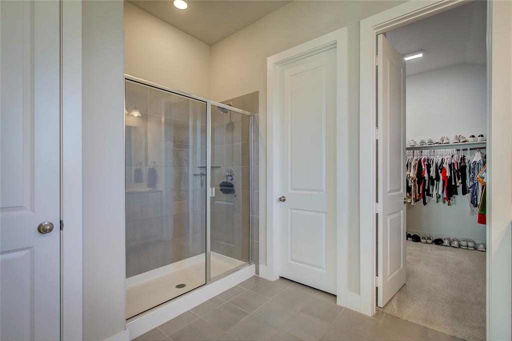 1872 Big Spring Drive Forney, TX 75126 - Photo 19 of 40 a view of a bathroom with a glass shower door