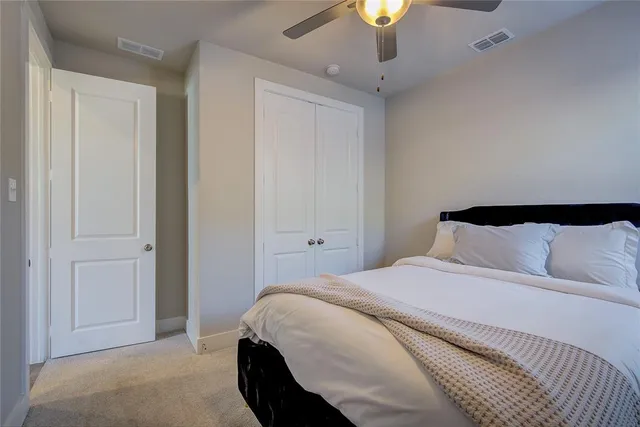 a bedroom with a bed and lamps