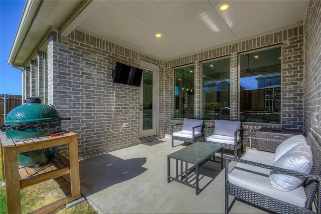 a view of a chairs and backyard with a tub