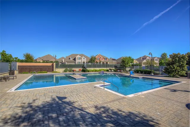 a view of a swimming pool with a patio