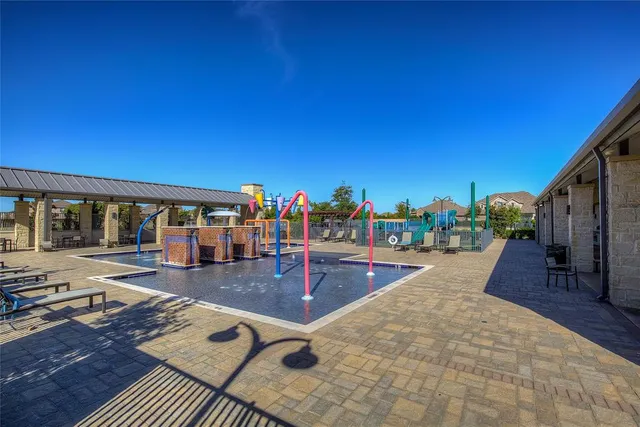 a view of a swimming pool with seating space