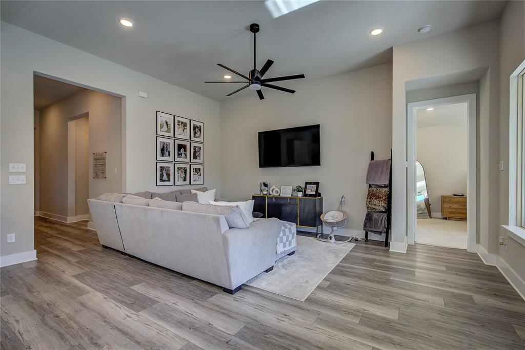 1872 Big Spring Drive Forney, TX 75126 - Photo 6 of 40 a living room with furniture a flat screen tv and a ceiling fan