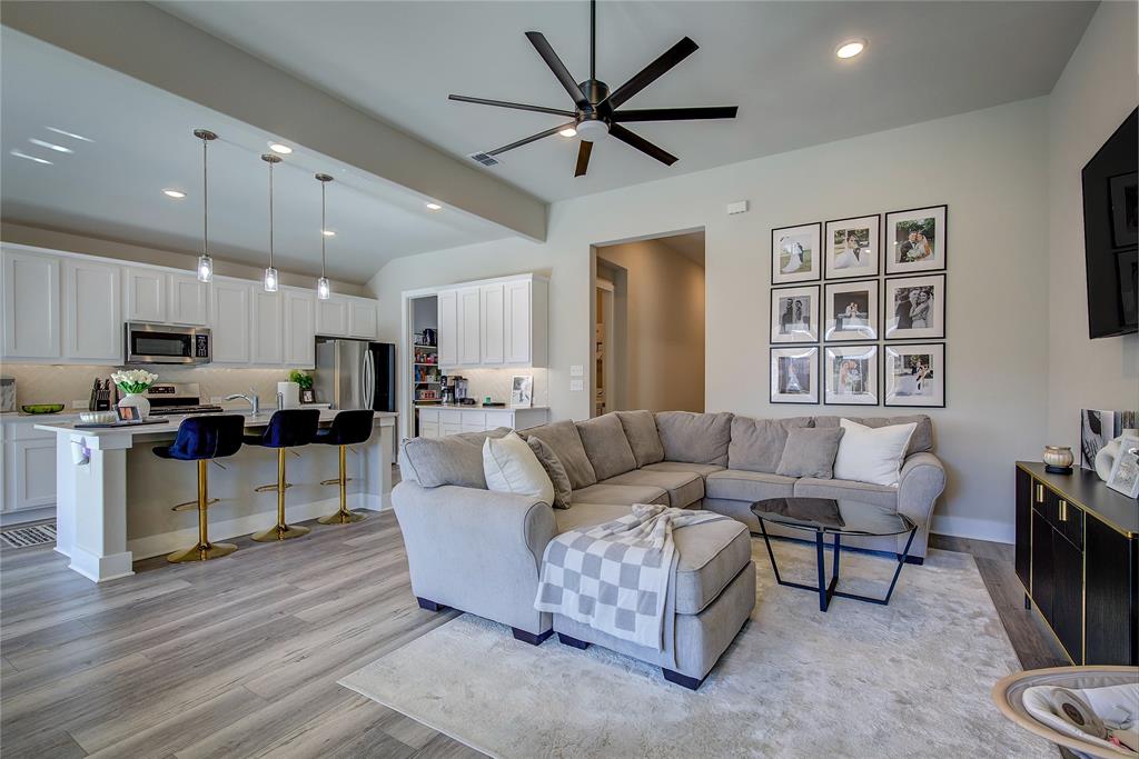 1872 Big Spring Drive Forney, TX 75126 - Photo 9 of 40 a living room with furniture kitchen view and a wooden floor