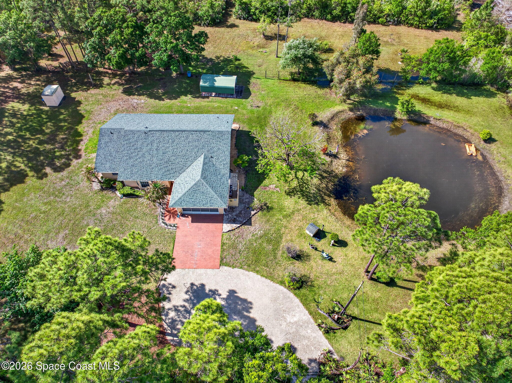 1455 Atz Road Malabar, FL 32950 - Photo 11 of 73 an aerial view of a house with a yard and lake view