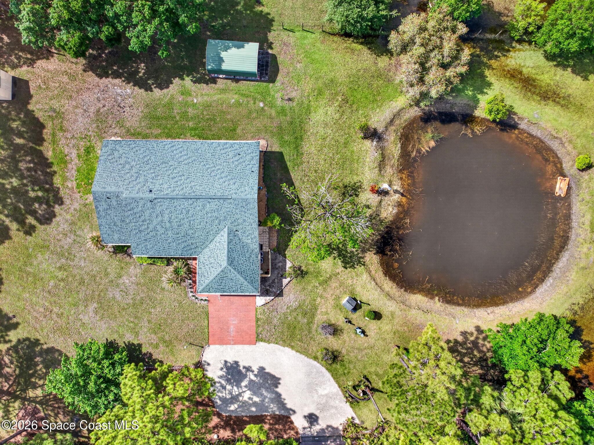 1455 Atz Road Malabar, FL 32950 - Photo 18 of 72 an aerial view of a house with a yard and trees