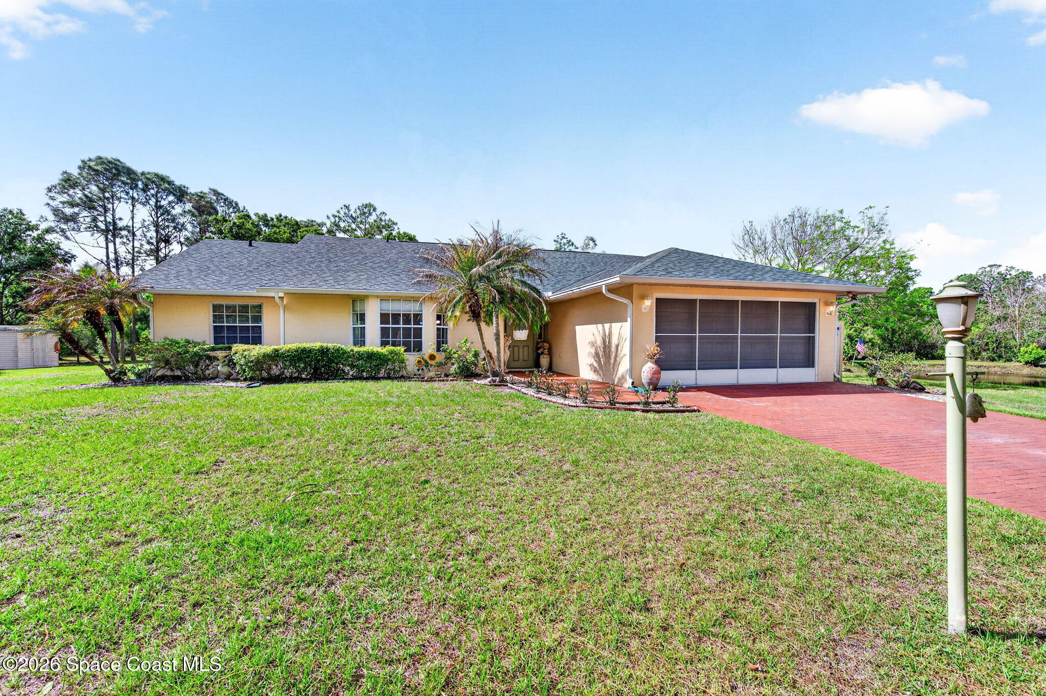 1455 Atz Road Malabar, FL 32950 - Photo 20 of 72 a front view of a house with garden