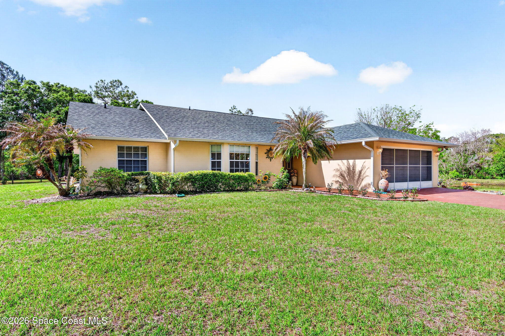 1455 Atz Road Malabar, FL 32950 - Photo 20 of 73 a front view of a house with garden