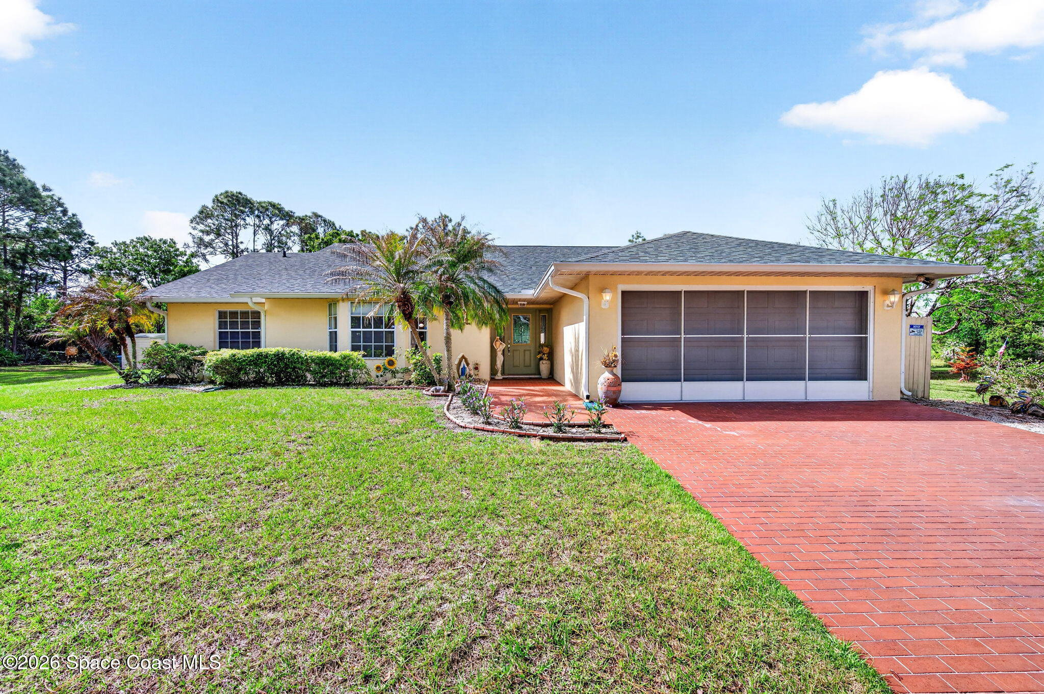 1455 Atz Road Malabar, FL 32950 - Photo 21 of 72 a front view of a house with a yard and garage