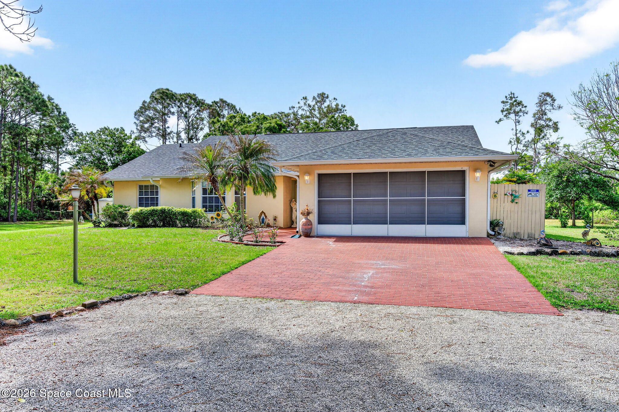 1455 Atz Road Malabar, FL 32950 - Photo 23 of 73 a front view of a house with a yard and garage