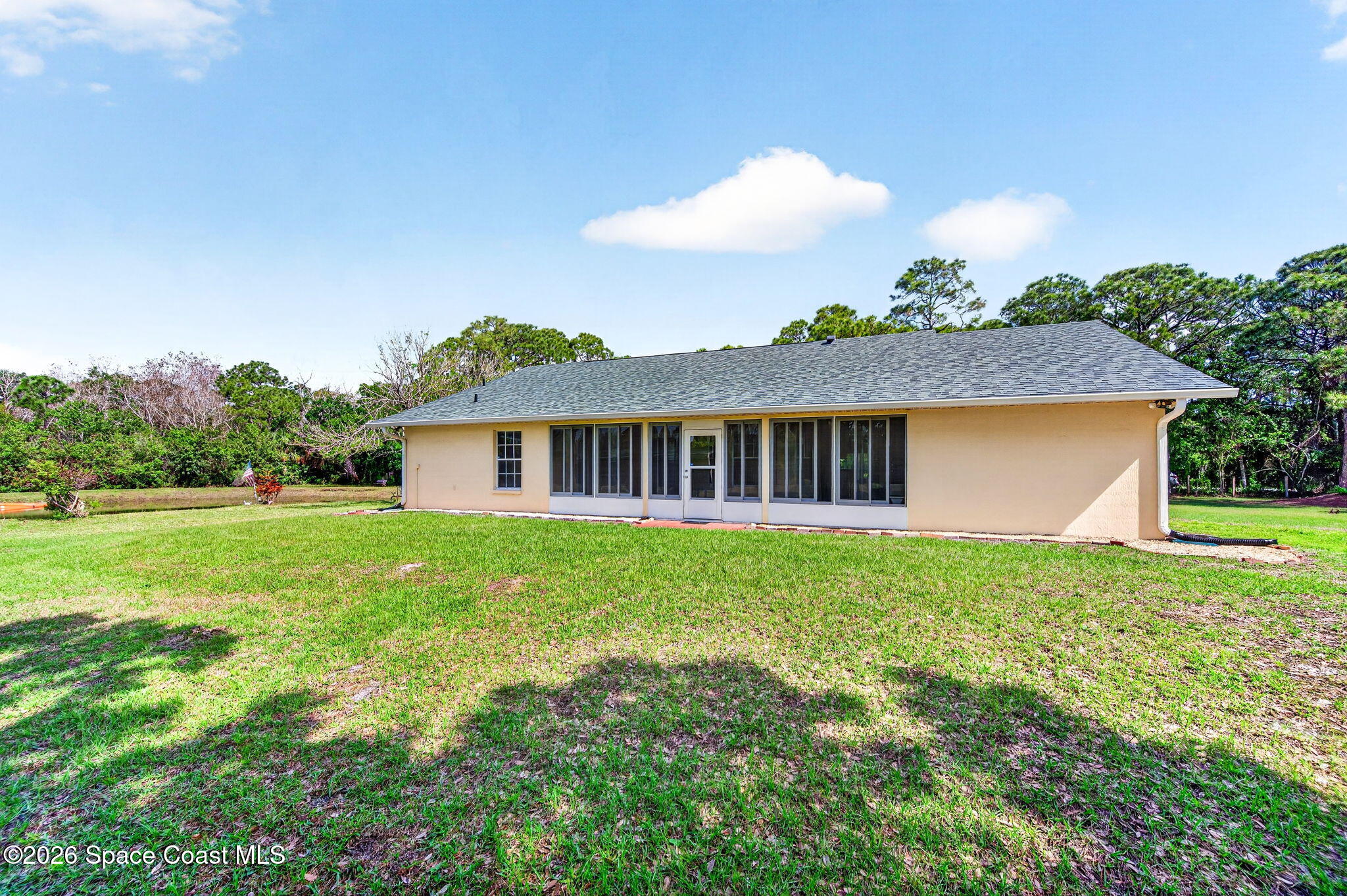 1455 Atz Road Malabar, FL 32950 - Photo 23 of 72 a view of a house with a big yard and potted plants