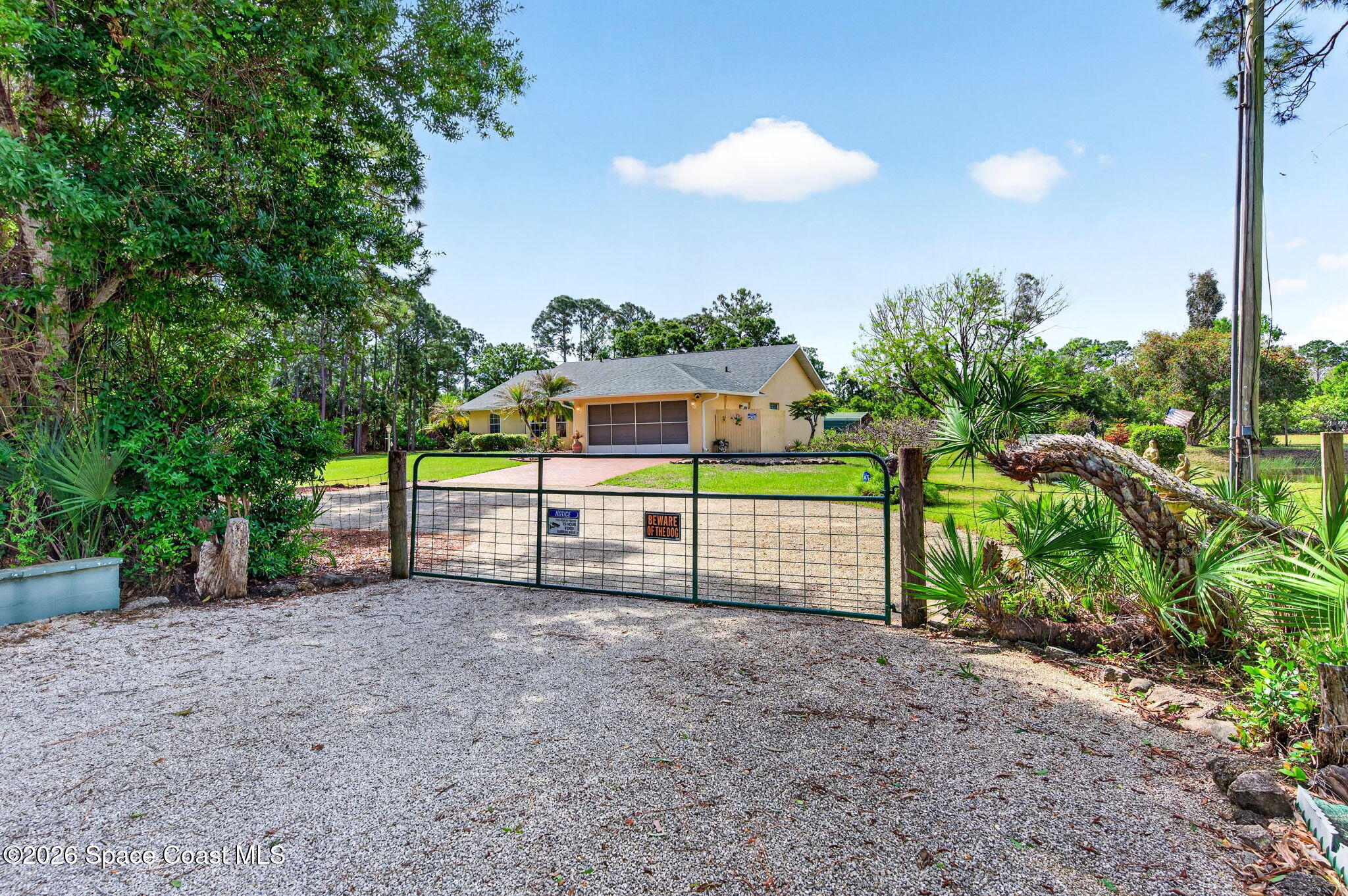 1455 Atz Road Malabar, FL 32950 - Photo 28 of 73 a view of a house with a backyard and a tree