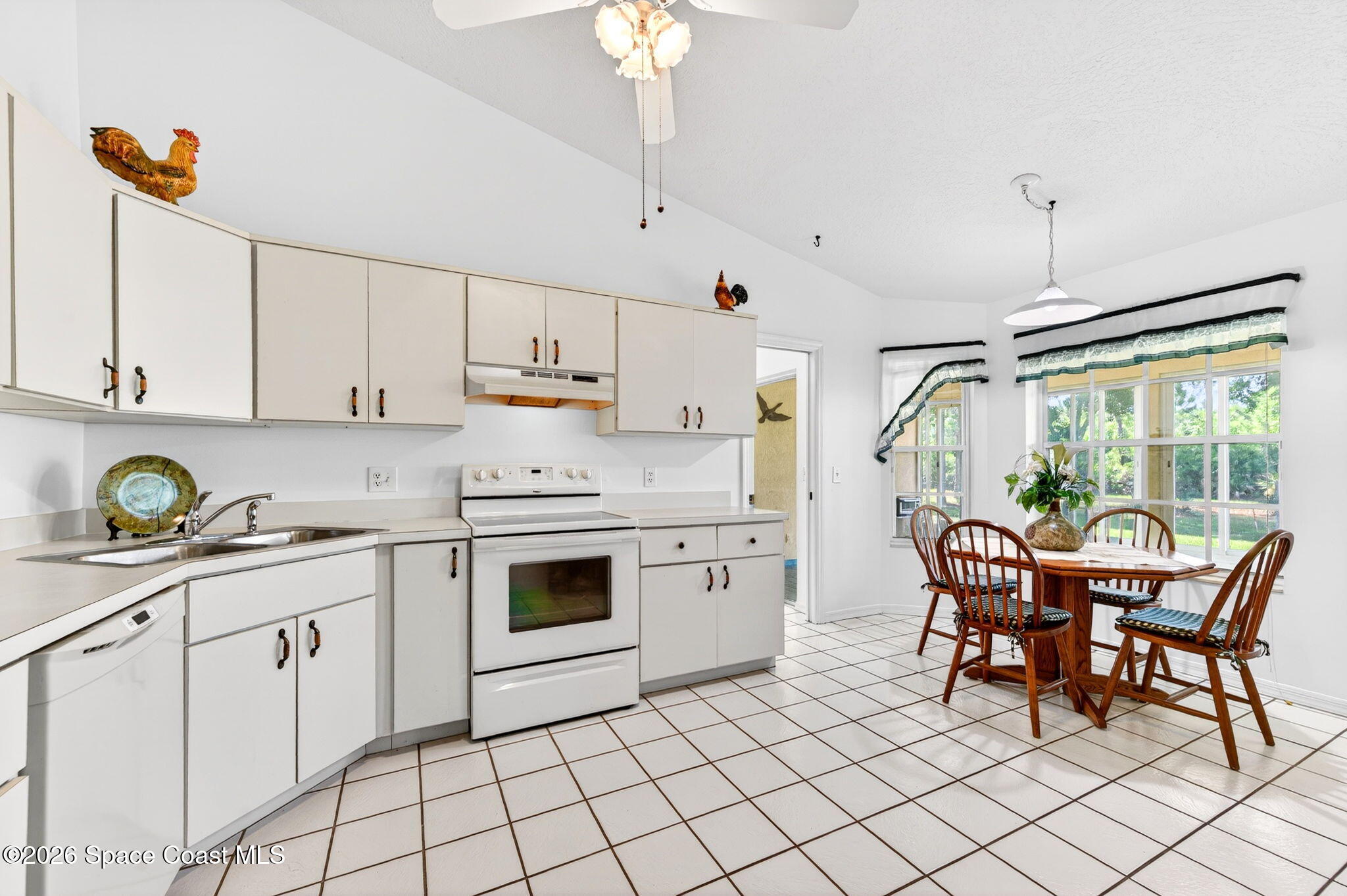 1455 Atz Road Malabar, FL 32950 - Photo 35 of 72 a kitchen with stainless steel appliances granite countertop a white cabinets and a stove