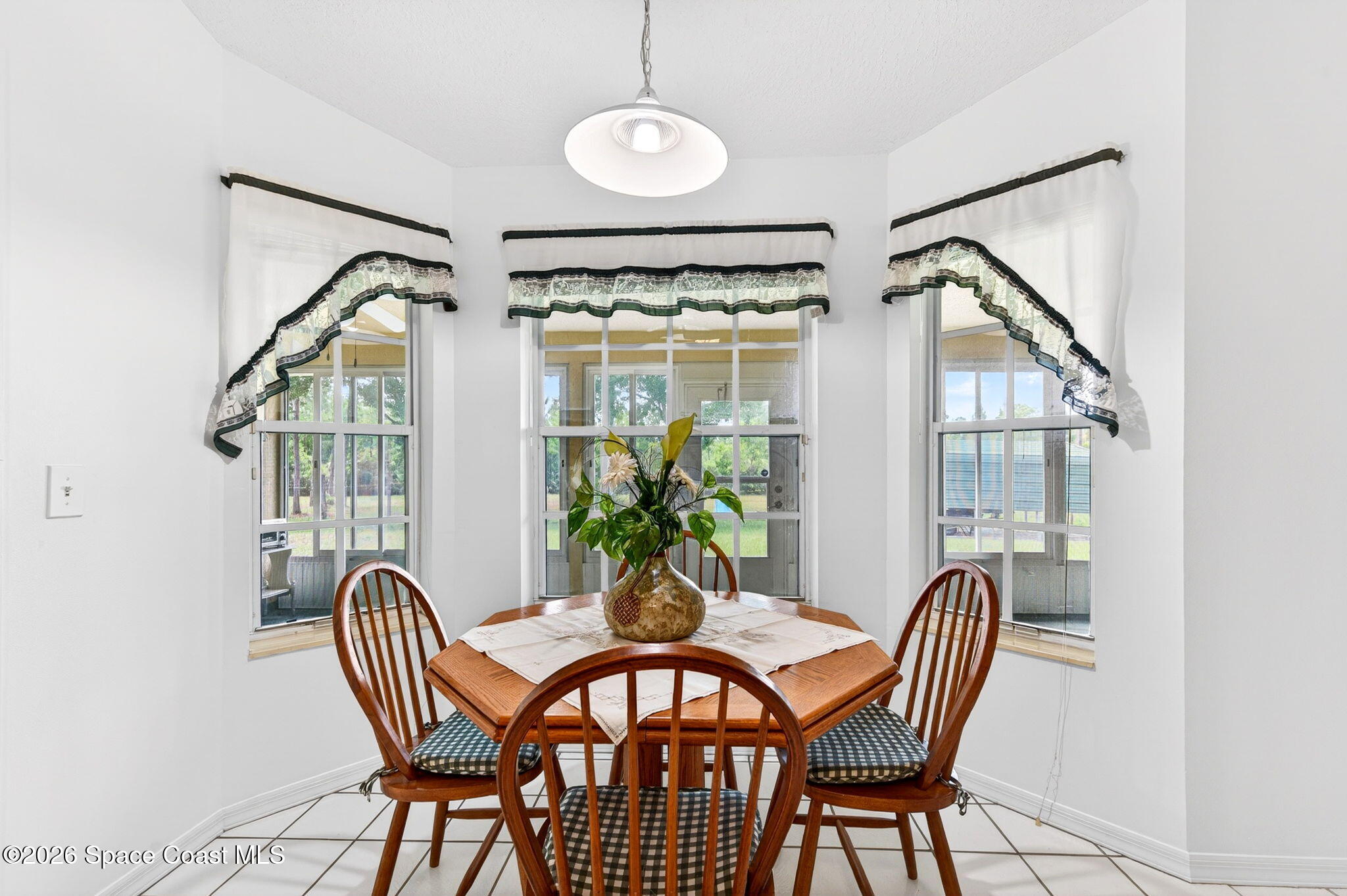 1455 Atz Road Malabar, FL 32950 - Photo 38 of 72 a view of a dining room with furniture window and outside view