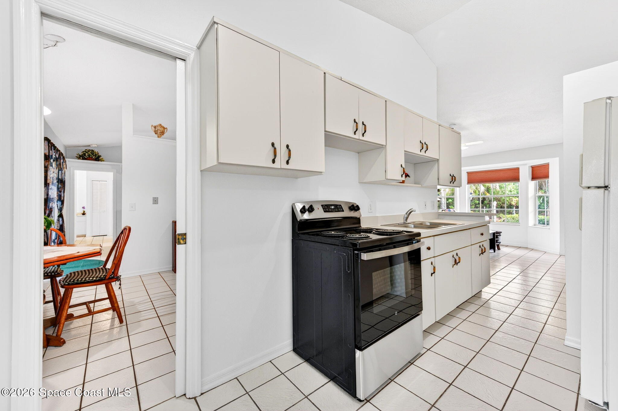 1455 Atz Road Malabar, FL 32950 - Photo 49 of 73 a kitchen with stainless steel appliances granite countertop a stove a sink and a refrigerator