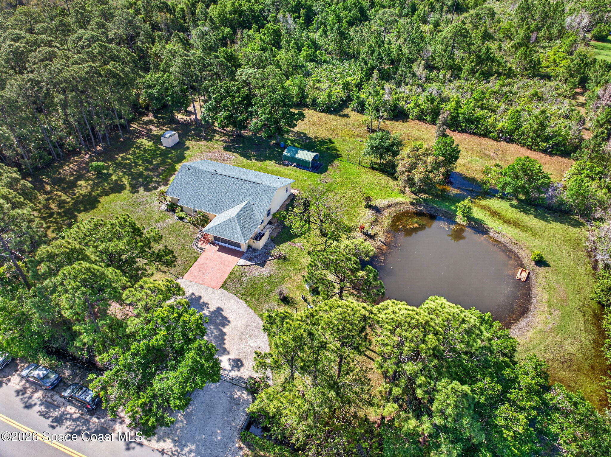 1455 Atz Road Malabar, FL 32950 - Photo 6 of 72 an aerial view of a house with a yard and trees