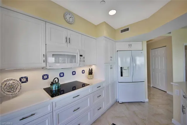 a kitchen with stainless steel appliances cabinets and a window