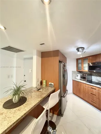 a living room with stainless steel appliances kitchen island granite countertop furniture and a kitchen view