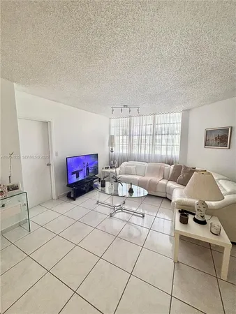 a living room with furniture a table and a window