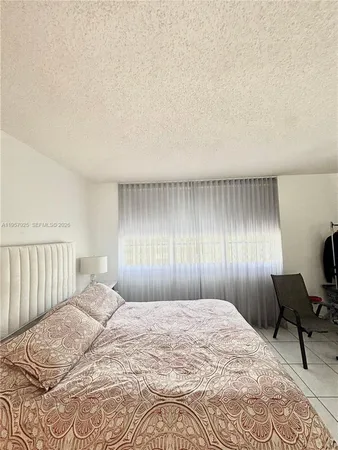 a bedroom with a bed and a chair