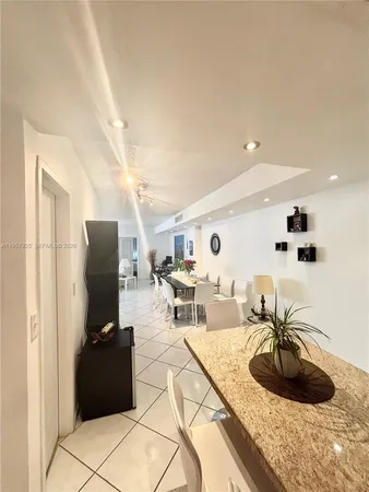 a living room with furniture a flat screen tv and a table