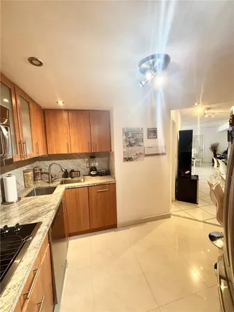a large kitchen with a large counter top appliances and cabinets