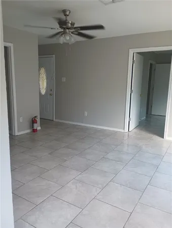 en empty room with fan and window