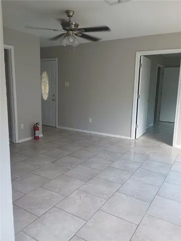 en empty room with fan and window