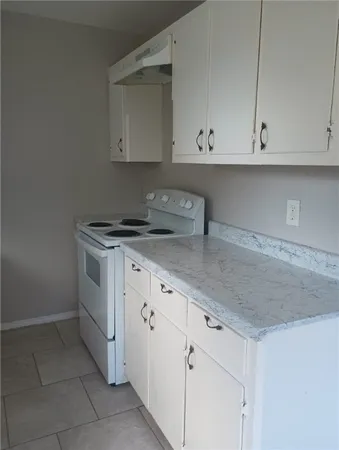 a kitchen with white cabinets