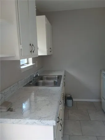 a kitchen with a sink and cabinets