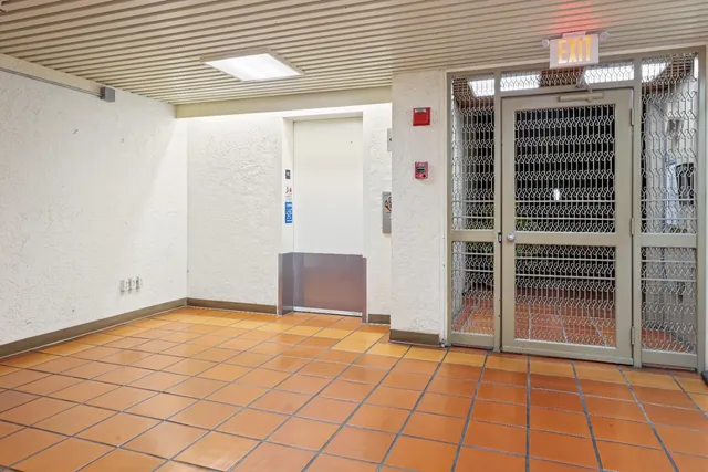 a view of parking garage with cars parked