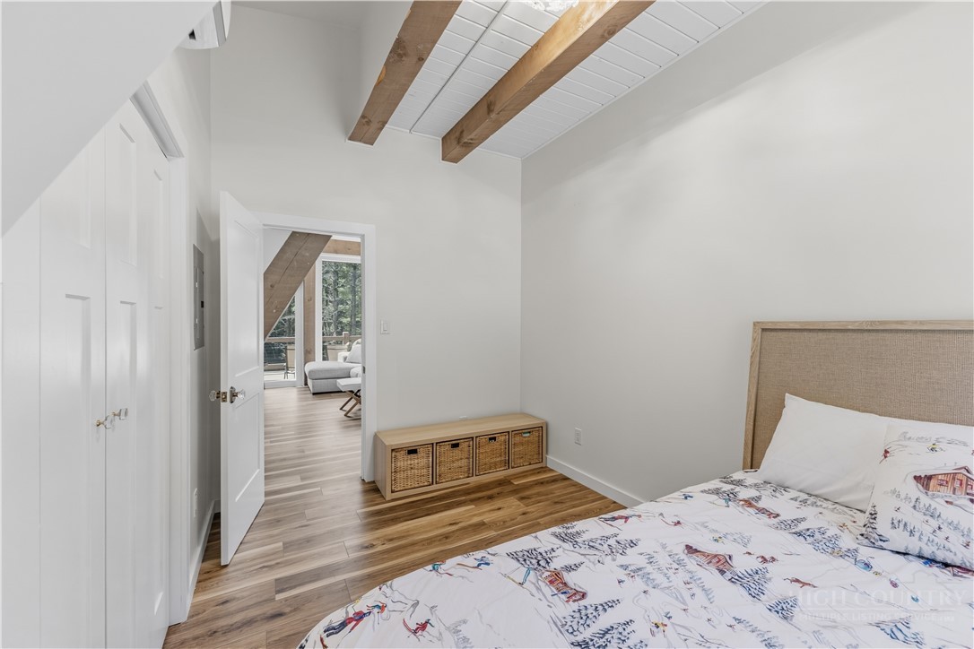 355 South River Hills Road Lansing, NC 28643 - Photo 25 of 45 a bedroom with a bed and wooden floor