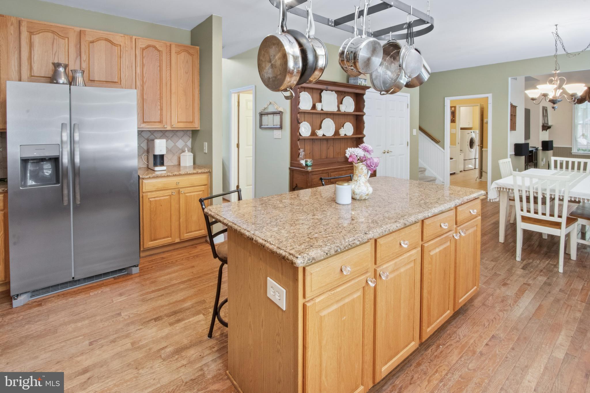 15 Hollybrook Road Mullica Hill, NJ 08062 - Photo 13 of 38 a kitchen with stainless steel appliances granite countertop a kitchen island a stove a refrigerator cabinets and chairs